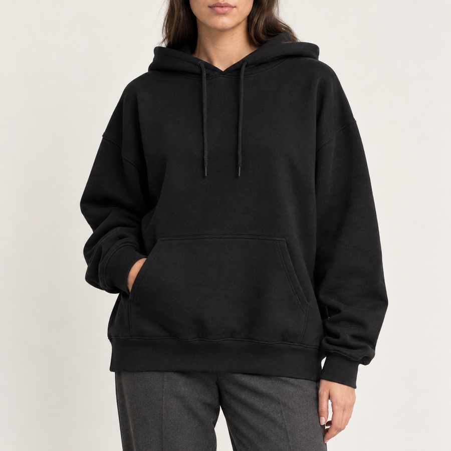 Model wearing the oversized hoodie in black with grey trousers