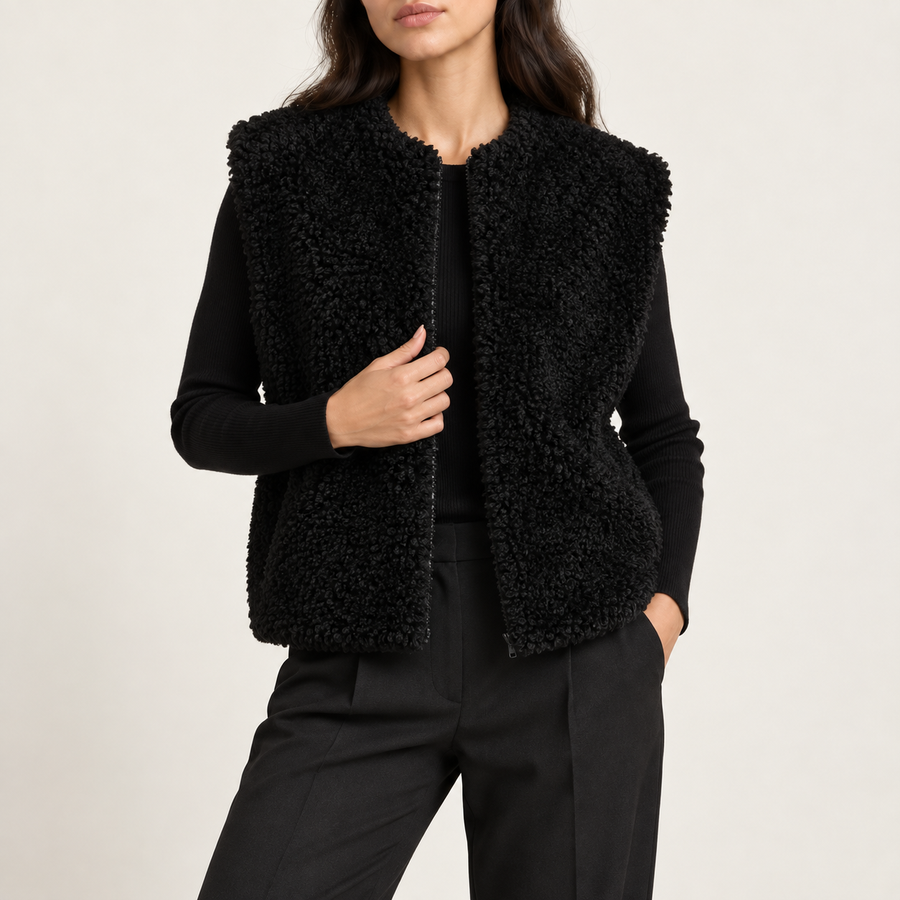 Model wearing the teddy zip gilet in black over a black top and trousers
